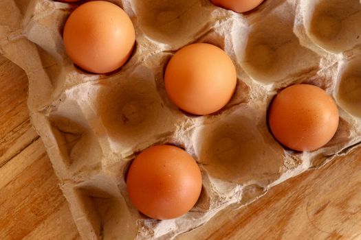 Thirty brown chicken eggs in a cardboard tray packaging. Raw fresh hen eggs in a carton box. Egg pattern background for easter, breakfast, cuisine. Top view