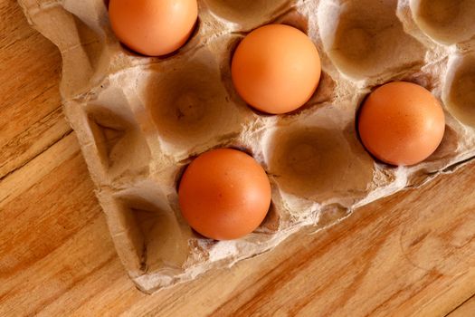 Thirty brown chicken eggs in a cardboard tray packaging. Raw fresh hen eggs in a carton box. Egg pattern background for easter, breakfast, cuisine. Top view