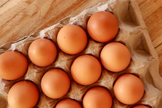 Thirty brown chicken eggs in a cardboard tray packaging. Raw fresh hen eggs in a carton box. Egg pattern background for easter, breakfast, cuisine. Top view