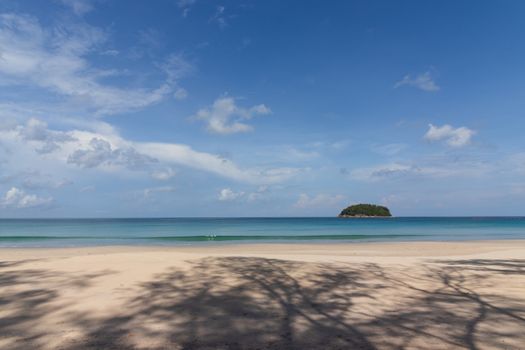 beautifull empty beach with small island in the blue sea and clear sky