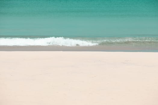 white sandy beach and turquoise sea water on sunny day