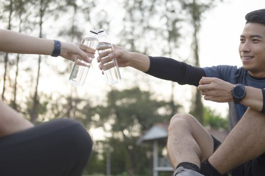 Young couple sporter drinking water after workout.