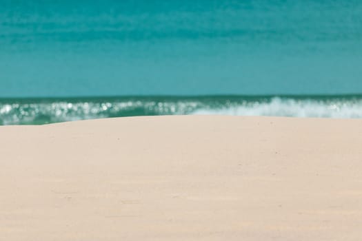 white sandy beach and turquoise sea water on sunny day