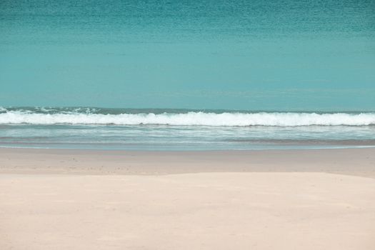 white sandy beach and turquoise sea water on sunny day