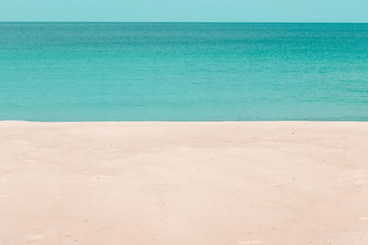 white sandy beach and turquoise sea water on sunny day