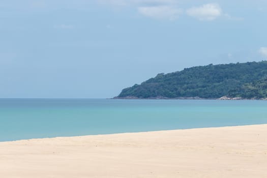 white sandy beach and turquoise sea water on sunny day