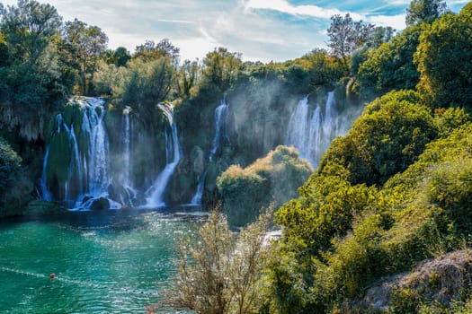 Kravice waterfall in Bosnia and Herzegovina, jets of water falling from a height of twenty-five meters among greenery