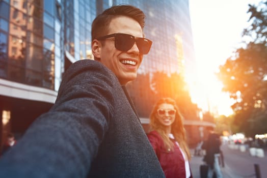 Beautiful young loving couple carrying shopping bags and enjoying together. Picture showing young couple shopping in the city.