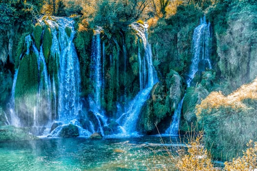 Kravice waterfall in Bosnia and Herzegovina, jets of water falling from a height of twenty-five meters among greenery