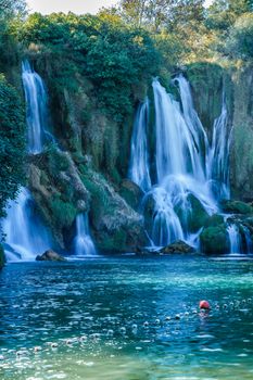 Kravice waterfall in Bosnia and Herzegovina, jets of water falling from a height of twenty-five meters among greenery