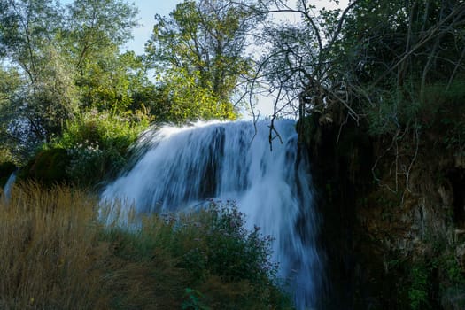 Kravice waterfall in Bosnia and Herzegovina, jets of water falling from a height of twenty-five meters among greenery