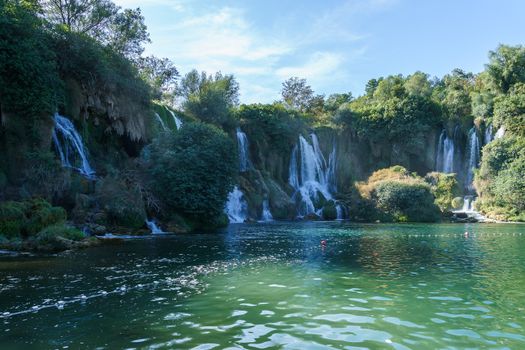 Kravice waterfall in Bosnia and Herzegovina, jets of water falling from a height of twenty-five meters among greenery