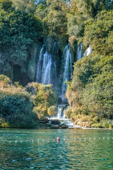 Kravice waterfall in Bosnia and Herzegovina, jets of water falling from a height of twenty-five meters among greenery