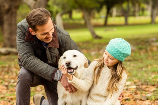 Young family with a dog on an autumns day