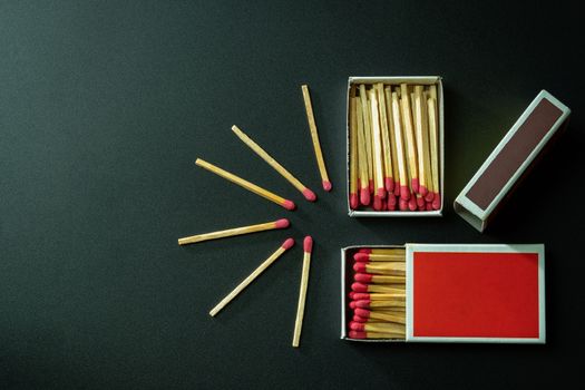 Box matches stick in red paper box on black background. Top view and copy space.