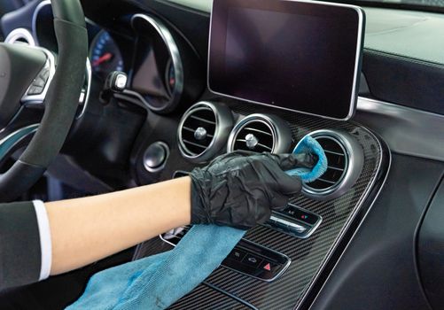 manual cleaning of the interior of luxury cars in the garage