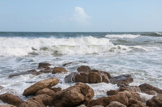 Waves crash on a rocky beach.