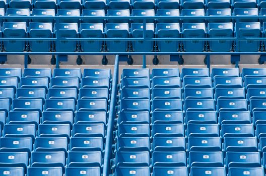 Blue seats in a sports stadium.