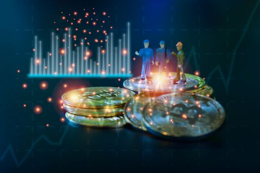 Miniature people teamworks, small model human figure standing on golden coins stack with blue and white graph. Cryptocurrency or digital money concept.