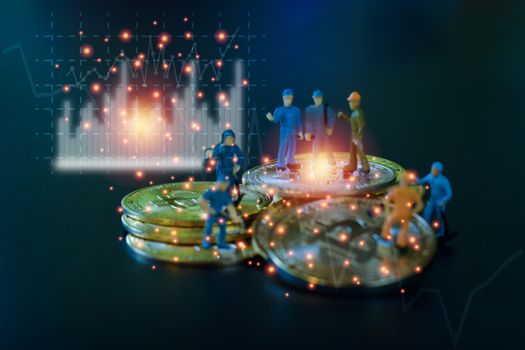 Miniature people teamworks, small model human figure standing on golden coins stack with blue and white graph. Cryptocurrency or digital money concept.