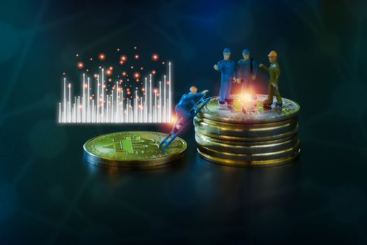 Miniature people teamworks, small model human figure standing on golden coins stack with blue and white graph. Cryptocurrency or digital money concept.