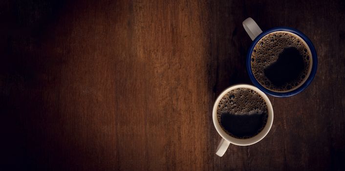 Cup of coffee on wooden background. Copy space. Top view. Flat lay. Panorama
