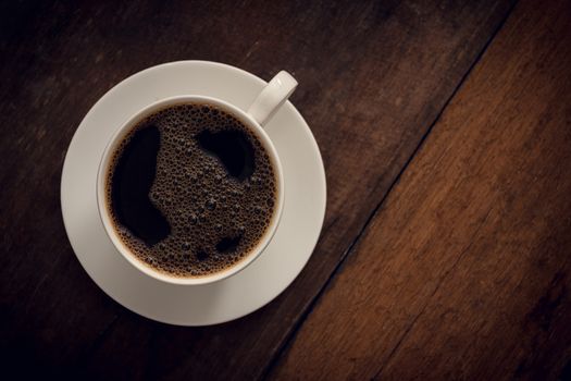 Cup of coffee on wooden background. Copy space. Top view. Flat lay