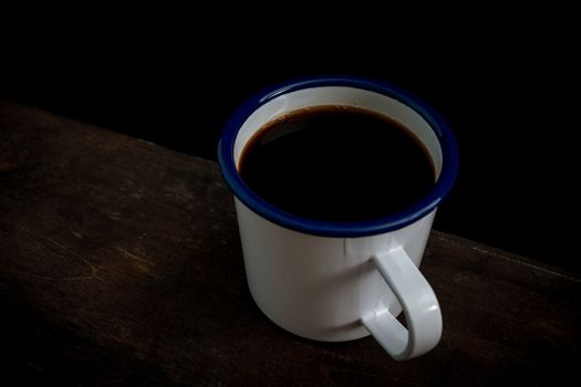 Cup of coffee on old wooden table