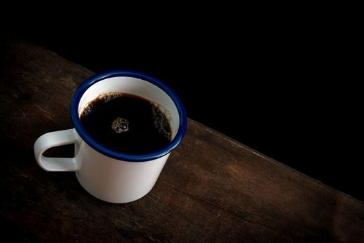Cup of coffee on old wooden table