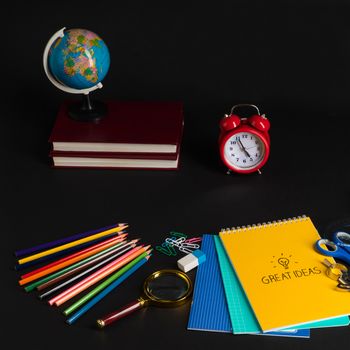 colorful collection of school supplies set on black background. back to school. great ideas
