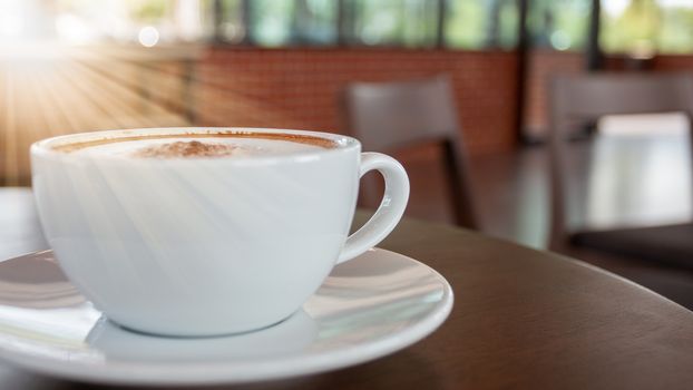 Coffee cup of cappuccino in cafe in an empty cafe without people.