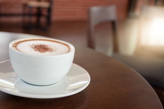 Coffee cup of cappuccino in cafe in an empty cafe without people.