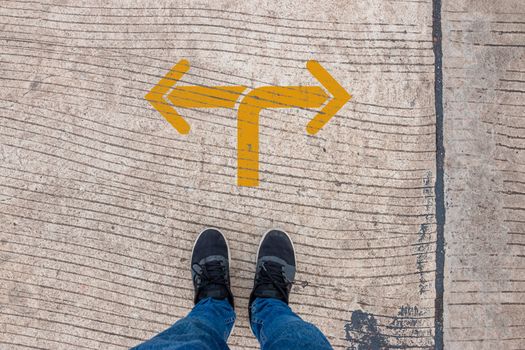 Go left or right. a man standing on the road thinking about choices, turning point concept