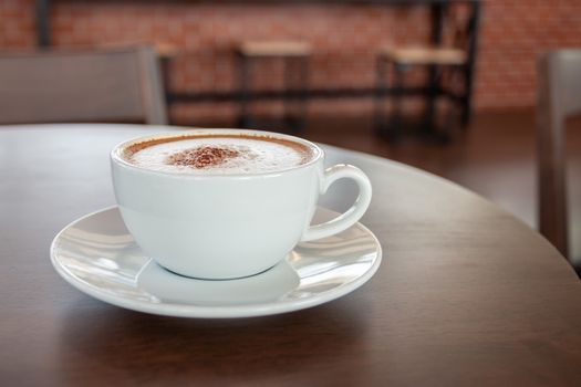 Coffee cup of cappuccino in cafe in an empty cafe without people.