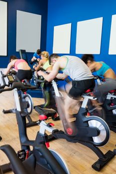 Fit people in a spin class at the gym