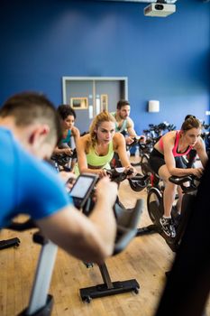 Fit people in a spin class at the gym