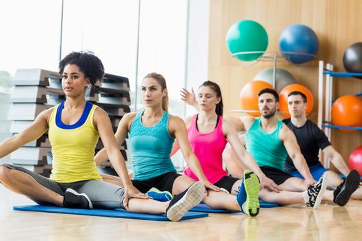 Fitness class exercising in the studio at the gym