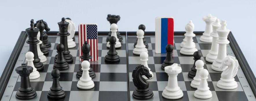 Symbols flag of Russia and the United States on the chessboard. The concept of political game.