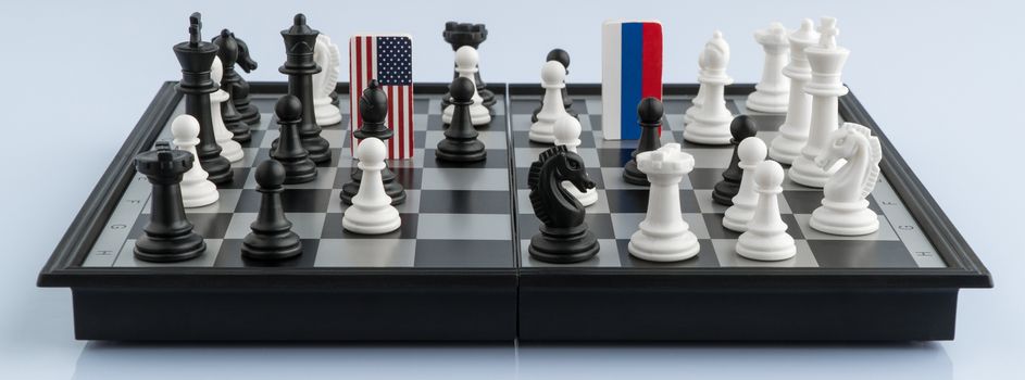 Symbols flag of Russia and the United States on the chessboard. The concept of political game.