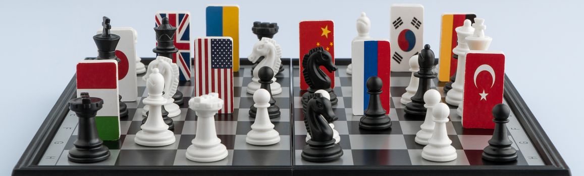 Symbols of the flags of the world on the chessboard. The concept of political game.