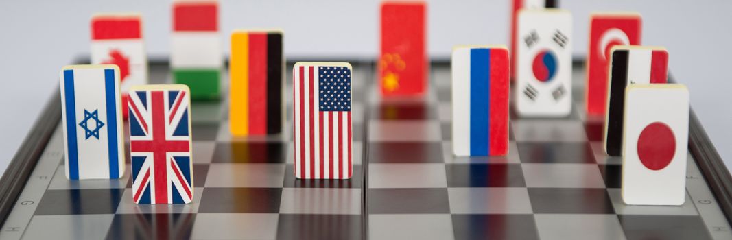 Symbols of the countries on the chess Board. Conceptual photo, political games. Close-up
