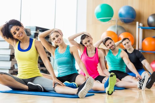 Fitness class exercising in the studio at the gym