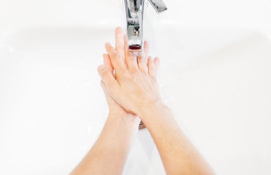 Man washing his hands hygienically with soap