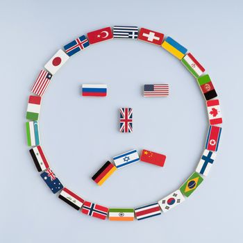 illustration of a smiley face from national flags on dominoes. Concept of peace and the Commonwealth of Nations and the world order