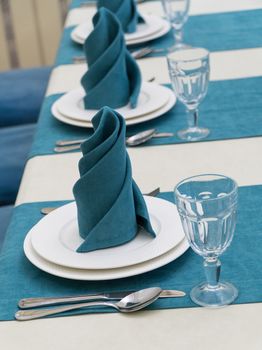 serving banquet table in a luxurious restaurant in turquoise and white style