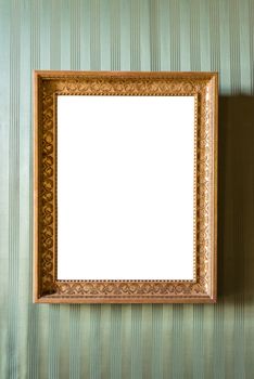 Empty golden picture frame on the green wall