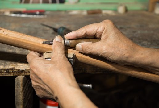 adult master restores old musical instruments. wood carving