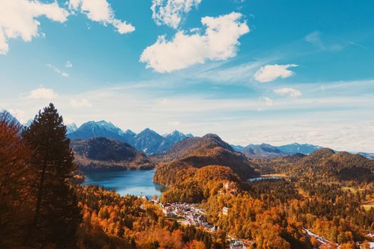 Beautiful nature of European Alps, landscape view of alpine mountains, lake and village in autumn season, travel and destination scenery