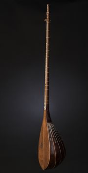 ancient Asian stringed musical instrument on black background with backlight