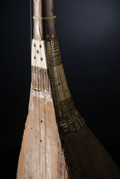 part ancient Asian stringed musical instrument on black background with backlight